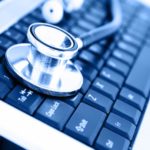 Close-up of stethoscope on laptop keyboard